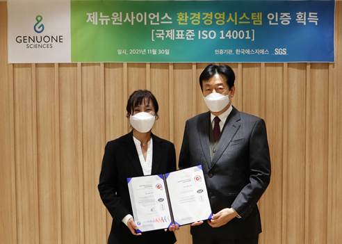 사진설명: 제뉴원사이언스 김미연 대표(왼쪽)와 한국에스지에스 박순곤 상무(오른쪽)가 ISO 14001 인증서 수여식에서 기념사진을 촬영하고 있다.]